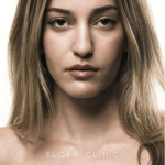 Front-facing portrait of a woman with highlighted hair and Elora Clinic lettering.